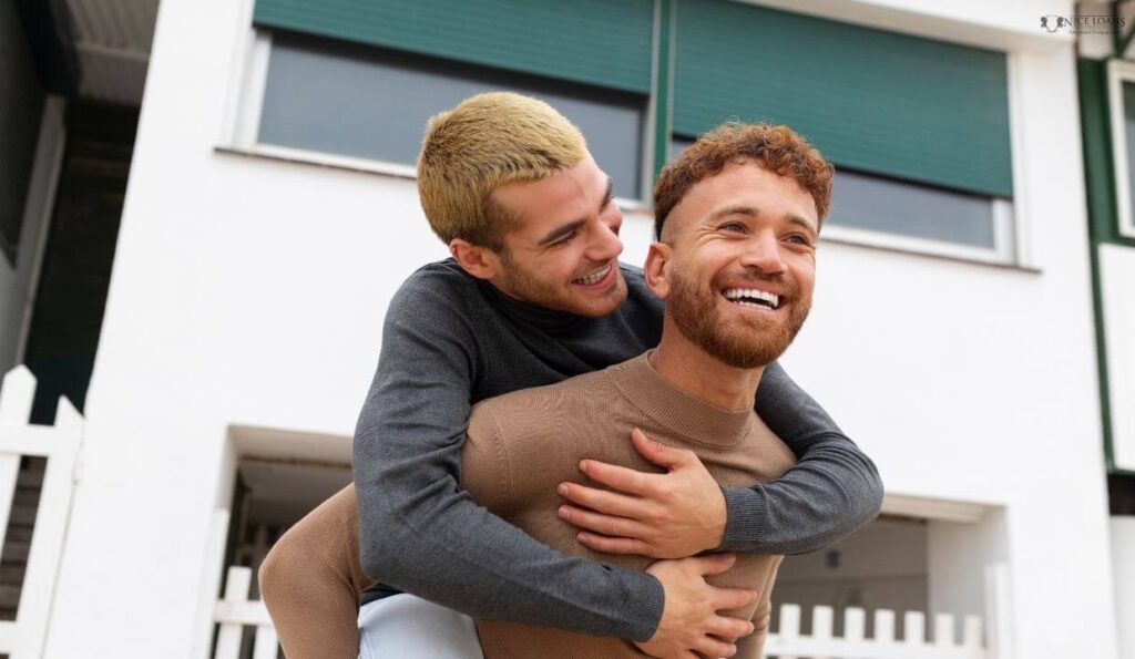 A happy gay couple before their new property.  