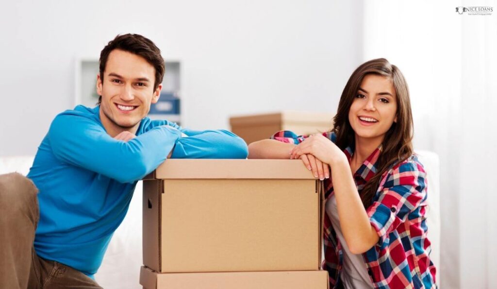 A couple with two stacked cardboard boxes between them.