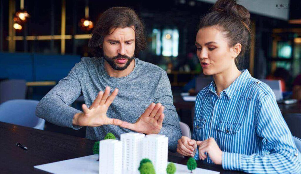 a man and woman discussing a build concept.