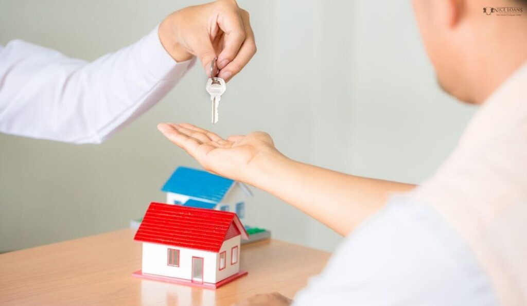 A manager providing home keys to a customer with all the deals signed. 