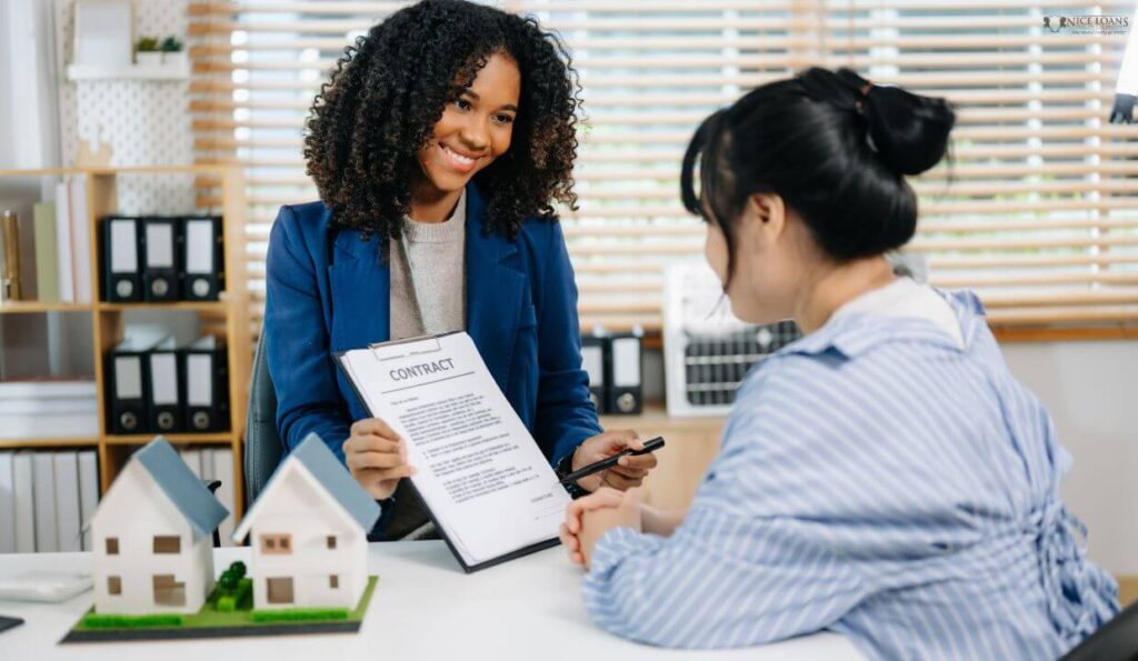 a mortgage broker showing a contract to a client who is about to sign it. 