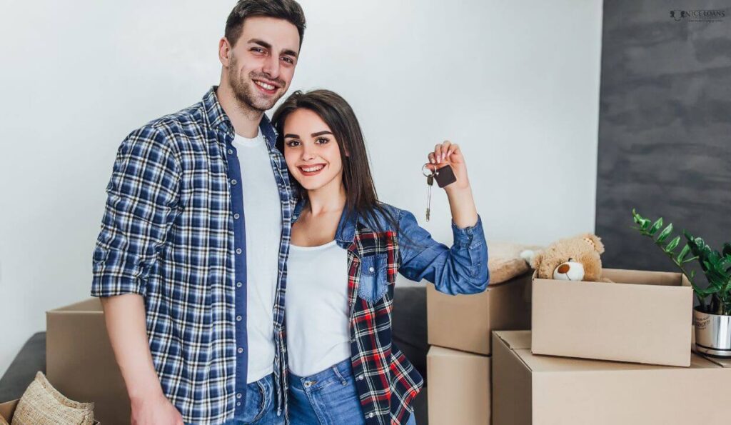 a couple with the keys of their second home looking happy.