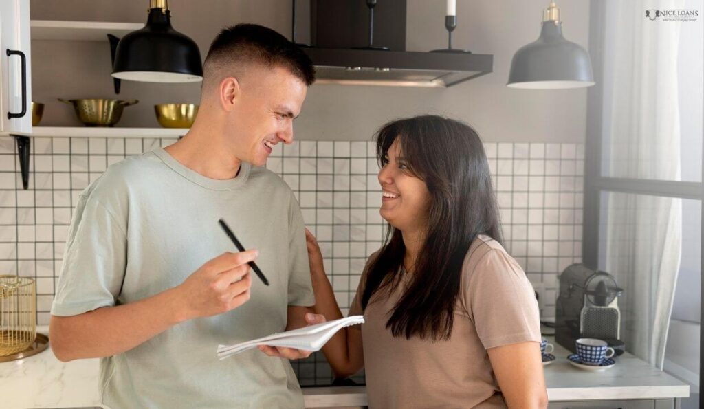 a man and woman in their kitchen preparing their first home buyers checklist