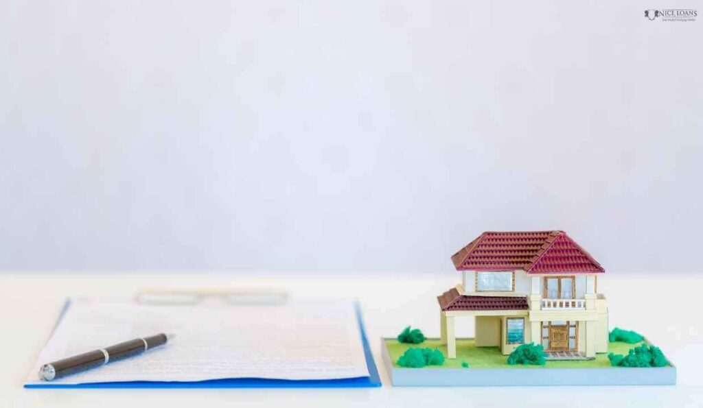 A document and a model house on a table. 