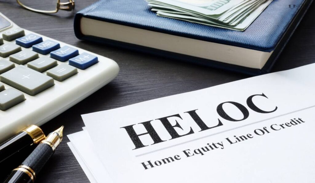 A close-up of a notebook, a calculator, a pen and a document with home equity line of credit written on it. 