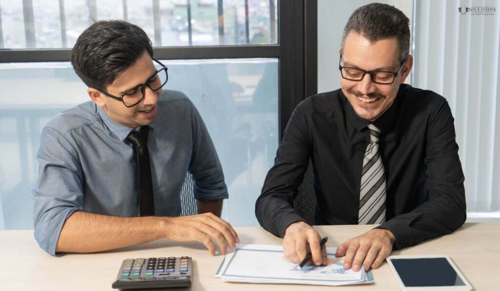 two partners discussing whether an owner occupier or investment loan is viable for their client