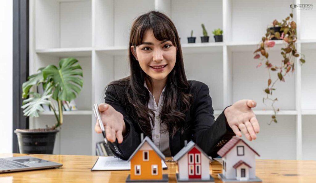woman in a suit pointing at three house models for a first home buyer to choose from.